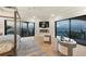 Bedroom featuring a four-poster bed, a fireplace, and floor-to-ceiling windows showcasing waterfront scenery at 641 Ranger Ln, Longboat Key, FL 34228