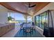 Elegant outdoor dining area with wood ceiling, plush seating and water view at 641 Ranger Ln, Longboat Key, FL 34228