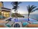 Infinity pool with views of the inter-coastal waterway and lounge seating at 641 Ranger Ln, Longboat Key, FL 34228