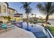 Backyard paradise with an infinity pool, lounge chairs, and views of the waterway at 641 Ranger Ln, Longboat Key, FL 34228