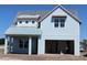 Beautiful two-story home featuring light blue siding and an attached two-car garage at 658 Maldives Trl, Sarasota, FL 34234