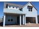 Charming two-story home with a light blue exterior and attached garage at 658 Maldives Trl, Sarasota, FL 34234