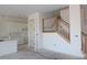 Spacious foyer with staircase and entrance to the modern kitchen at 658 Maldives Trl, Sarasota, FL 34234