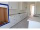 Bright kitchen with modern white cabinets, quartz countertops, and stainless sink at 658 Maldives Trl, Sarasota, FL 34234