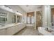 Luxurious bathroom with double vanity, soaking tub, walk-in shower, and elegant finishes at 6919 Dominion Ln, Lakewood Ranch, FL 34202