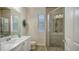Bright bathroom with tiled walk-in shower and single sink vanity at 6919 Dominion Ln, Lakewood Ranch, FL 34202