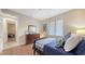 Bright bedroom with wood look floors, natural light, and artwork at 6919 Dominion Ln, Lakewood Ranch, FL 34202