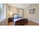 Bedroom with a window, wood floors, a ceiling fan, soft walls, and an art print at 6919 Dominion Ln, Lakewood Ranch, FL 34202