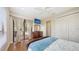 Bright bedroom with wood floors and slider leading to the pool area at 6919 Dominion Ln, Lakewood Ranch, FL 34202