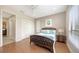 Bedroom with hardwood floors, closet, and a large window offering serene outdoor views at 6919 Dominion Ln, Lakewood Ranch, FL 34202