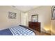 Cozy bedroom with wood look floors, natural light, and artwork at 6919 Dominion Ln, Lakewood Ranch, FL 34202