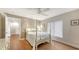 Inviting bedroom with wood floors, ceiling fan, white walls, and comfortable furnishings at 6919 Dominion Ln, Lakewood Ranch, FL 34202