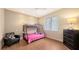 Bright bedroom with a bunk bed, laminate floors, and a comfortable armchair at 6919 Dominion Ln, Lakewood Ranch, FL 34202