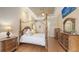 Bedroom with a four poster bed, wood floors, decorative ceiling, and elegant furnishings at 6919 Dominion Ln, Lakewood Ranch, FL 34202