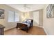 Bedroom with a wooden bed, wood floors, a ceiling fan, and a good-sized window at 6919 Dominion Ln, Lakewood Ranch, FL 34202