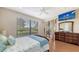 Comfortable bedroom with natural light, ceiling fan and wooden floors at 6919 Dominion Ln, Lakewood Ranch, FL 34202