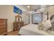 Spacious bedroom with a four-poster bed, wood floors, and stylish wooden furniture at 6919 Dominion Ln, Lakewood Ranch, FL 34202