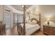 Bedroom with a four poster bed, wood flooring, and large windows offering ample natural light at 6919 Dominion Ln, Lakewood Ranch, FL 34202