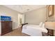 Bright bedroom with TV, ceiling fan, wood-look floors, and closet at 6919 Dominion Ln, Lakewood Ranch, FL 34202