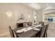 An elegant dining room features a decorative chandelier, sconces, and views into other rooms at 6919 Dominion Ln, Lakewood Ranch, FL 34202