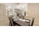 The dining room has a dark wood table, seating for six, and chandelier lighting at 6919 Dominion Ln, Lakewood Ranch, FL 34202