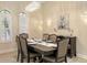 A dining room with large windows, a chandelier, and a view of the outside at 6919 Dominion Ln, Lakewood Ranch, FL 34202