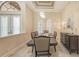 Well-lit dining area with decorative chandelier and views of the home's exterior at 6919 Dominion Ln, Lakewood Ranch, FL 34202