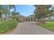 Stately home with a lush, landscaped front yard and circular driveway at 6919 Dominion Ln, Lakewood Ranch, FL 34202