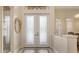 Elegant entryway with ornate glass double doors and arched transom window at 6919 Dominion Ln, Lakewood Ranch, FL 34202