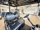 Garage interior featuring a new black golf cart at 6919 Dominion Ln, Lakewood Ranch, FL 34202