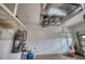 Well-lit garage featuring epoxy flooring, water heater, storage and a fire extinguisher at 6919 Dominion Ln, Lakewood Ranch, FL 34202