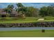 Scenic golf course view with lush green fairways, sand traps, and a tranquil lake in a beautiful community at 6919 Dominion Ln, Lakewood Ranch, FL 34202