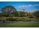 Picturesque golf course featuring rolling greens, a sand trap, and a serene lake, creating a tranquil setting at 6919 Dominion Ln, Lakewood Ranch, FL 34202