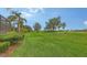 Scenic view of the golf course with lush landscaping, mature trees, and well-maintained lawns at 6919 Dominion Ln, Lakewood Ranch, FL 34202