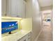 Hallway with a built-in desk featuring bright lighting and marble countertops at 6919 Dominion Ln, Lakewood Ranch, FL 34202