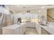 Modern kitchen with white cabinets, stainless steel appliances, and a kitchen island for cooking at 6919 Dominion Ln, Lakewood Ranch, FL 34202