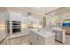 Stylish kitchen with stainless steel appliances, white cabinetry, and open layout to the living area at 6919 Dominion Ln, Lakewood Ranch, FL 34202