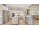 Spacious kitchen with white cabinetry, stainless steel appliances, island, and pendant lighting at 6919 Dominion Ln, Lakewood Ranch, FL 34202