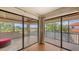 Enclosed lanai with tile flooring and sliding glass doors providing panoramic views of the community at 6919 Dominion Ln, Lakewood Ranch, FL 34202