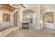 Comfortable living space features a fireplace, view to patio, and open layout to other rooms at 6919 Dominion Ln, Lakewood Ranch, FL 34202