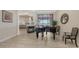Spacious living area with piano, fireplace, and access to outdoor patio at 6919 Dominion Ln, Lakewood Ranch, FL 34202