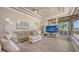 Spacious living room with large windows, comfortable seating, and a TV for entertainment at 6919 Dominion Ln, Lakewood Ranch, FL 34202