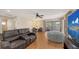 Bright living room featuring a leather sofa, sliding glass doors to a balcony, and wood-look flooring at 6919 Dominion Ln, Lakewood Ranch, FL 34202
