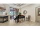 A grand living room boasts a piano, fireplace, and sliding doors to an outdoor patio at 6919 Dominion Ln, Lakewood Ranch, FL 34202
