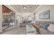 Comfortable living room with large sectional sofa, tray ceiling, and view to pool area at 6919 Dominion Ln, Lakewood Ranch, FL 34202