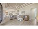 Open-concept living room featuring a sectional sofa, stylish decor, and seamless flow to the kitchen at 6919 Dominion Ln, Lakewood Ranch, FL 34202