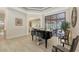 Open living area with high ceilings, piano, and lots of natural light at 6919 Dominion Ln, Lakewood Ranch, FL 34202
