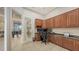 An office with built-in storage, granite counters, and natural light coming through glass doors at 6919 Dominion Ln, Lakewood Ranch, FL 34202