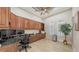 The office features a granite desk, hardwood cabinets, lots of light and decorative plants at 6919 Dominion Ln, Lakewood Ranch, FL 34202