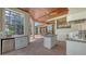 Outdoor kitchen with a built-in grill, island, and sink, perfect for poolside barbecues and entertainment at 6919 Dominion Ln, Lakewood Ranch, FL 34202